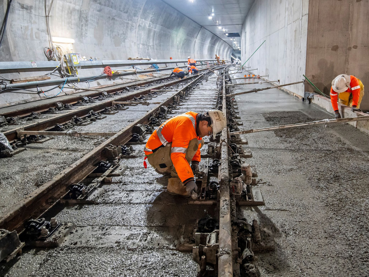 Workers finishing a fibre reinforced concrete tunnel track slab during construction of the Sydney Metro City & Southwest project.