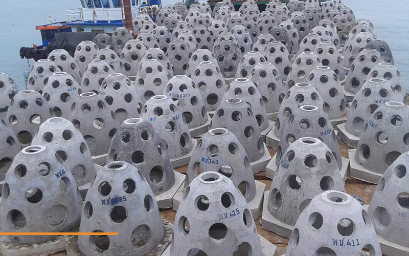 thin-shell-precast-coastal-domes-barchip-02 Hollow, perforated precast concrete domes ready for installation.