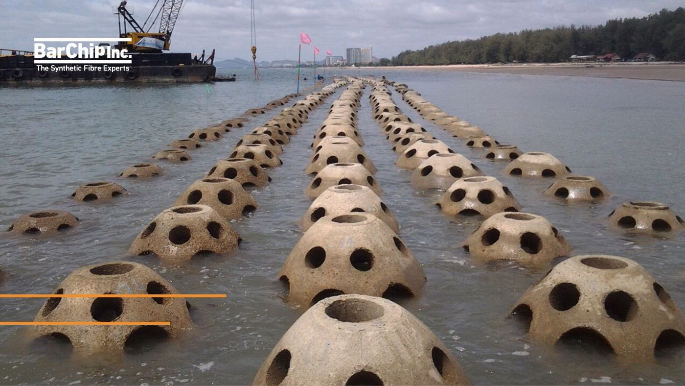 Thin shell fibre reinforced precast coastal domes installed for shoreline protection.