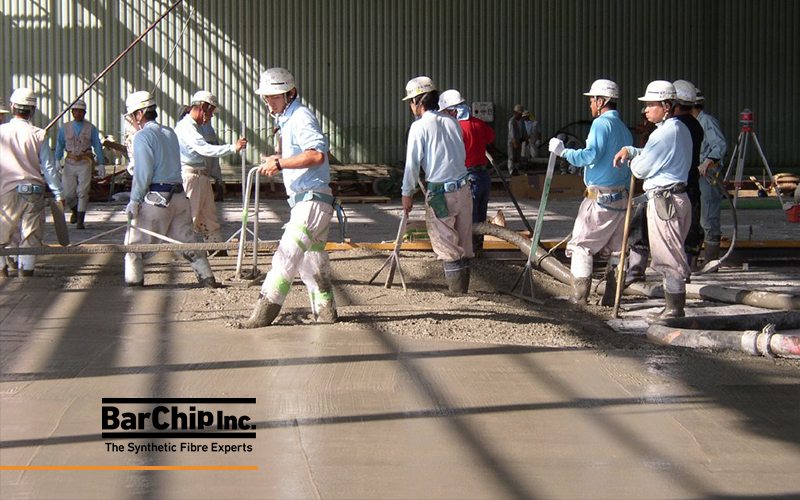 Workers finishing freshly placed fibre reinforced concrete at the Toyota Miyata Plant expansion.